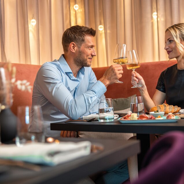 Couple toasting with white wine in a restaurant
