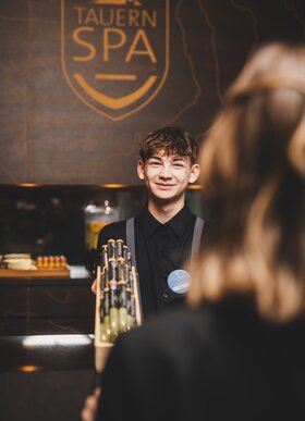 Smiling young man at the spa reception desk