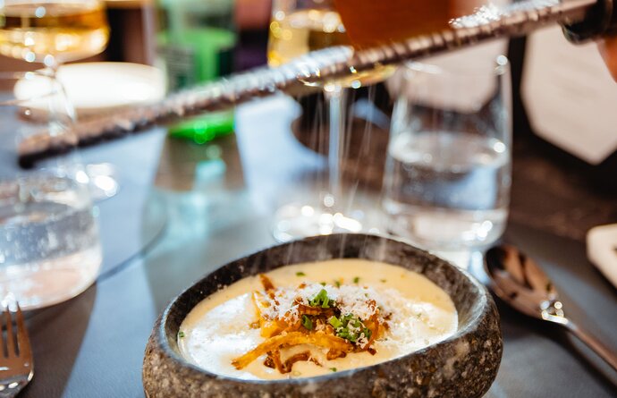 Dish in stone bowl is shaved with truffle
