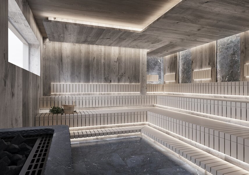 Moderne Holzsauna mit Stein und indirekter Beleuchtung