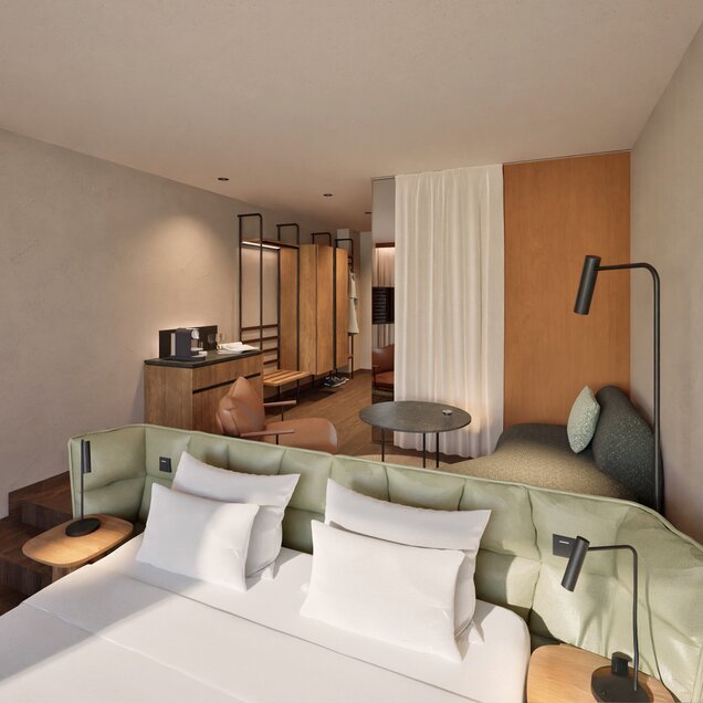 Modern hotel room with bright sleeping and living area
