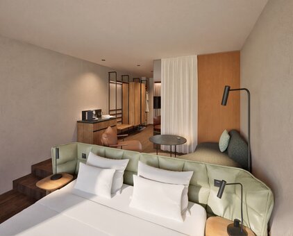 Modern hotel room with bright sleeping and living area