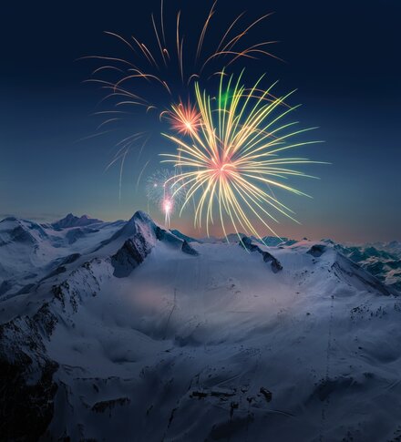 Fireworks over snow-covered mountains on the Kitzsteinhorn