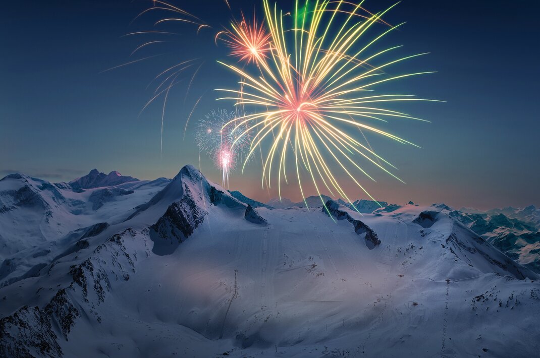 Fireworks over snow-covered mountains on the Kitzsteinhorn