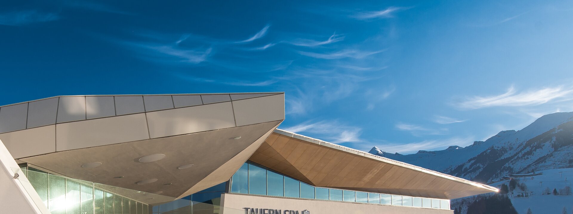 Taern Spa entrance at night with snow and blue sky