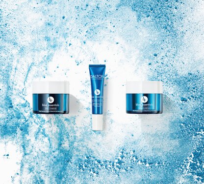 Three blue Dalton cosmetic products on an abstract blue and white background