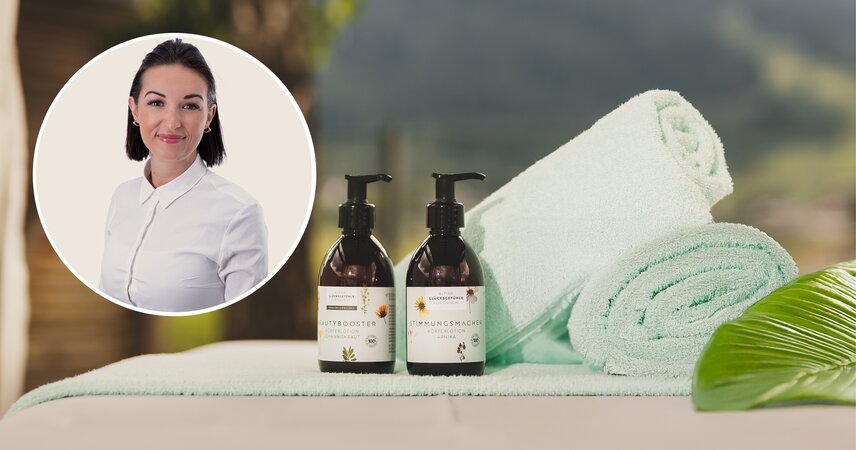 Zwei Körperlotionen, Handtücher und Frauenporträt